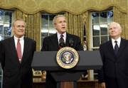 President Bush, center, is flanked by outgoing Defense Secretary Donald H. Rumsfeld, left, and his replacement nominee Robert Gates. Bush announced Wednesday that Rumsfeld would be leaving the post he had held for six years.