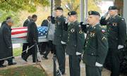 Fort Leavenworth honor guard members, from center, Pfc. Jon Westall, Pfc. David Tulette, Pvt. Sven Johnson and Pvt. Derek Stephansen-Fitzgerald salute as pall bearers for World War II veteran Leon Holmes, who died Oct. 17, make their way into the Committal Shelter on Oct. 25 at Fort Leavenworth National Cemetery. The honor guard appears at funerals of veterans and also "present the colors" at sports venues and other events.