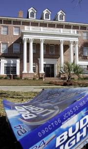 A discarded beer box lies in the front lawn of the Chi Psi Fraternity house Friday, Nov. 10, 2006, at the University of South Carolina in Columbia, S.C. A lawsuit was filed Thursday on behalf of two fraternity brothers who claim they were duped into appearing in the spoof documentary "Borat: Cultural Learnings of America for Make Benefit Glorious Nation of Kazakhstan," in which they made racist and sexist comments on camera.