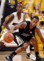 Army's Marshall Jackson, right, loses the ball as Missouri's Keon Lawrence defends. The Tigers claimed their second victory of the season, 67-58, Saturday in Columbia, Mo.