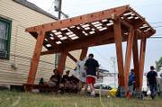 Kansas University architecture students lounge under a shade structure they built during the last school year. It is one of the early projects that KU students completed to assist New Orleans' Seventh Ward.