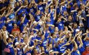 The student section waves the wheat during Tuesday night's exhibition game as an Emporia State player leaves the court, having fouled out in the Kansas Jayhawks' 90-55 win over the Hornets at Allen Fieldhouse.