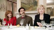 Comedian Sacha Baron Cohen, center, is shown in a scene from his comedy "Borat: Cultural Learnings of America for Make Benefit of Glorious Nation of Kazakhstan." With him are etiquette consultant Cindy Streit, left, and Sarah Moseley, both of Birmingham, Ala. The two unknowingly became the target of Baron Cohen&squot;s outrageous humor in his movie satire.