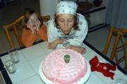 Ciara Ross, left, watches as her mother, Carmin Ross, blows out a candle two months before Carmin was murdered just outside Lawrence. Carmin's ex-husband, Thomas Murray, was convicted of her murder in March of 2005.
