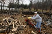 Bill Foust, property manager at Spirit Lake, a retreat center in southern Jefferson County, adds to his wood pile Tuesday afternoon while using a gas-powered splitter. Foust spent part of the day splitting the wood which he plans to sell and deliver this winter.