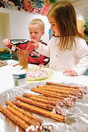 PETE JUNGE, left, and Parrish Mock make pretzel sticks in their preschool class at the Lawrence Arts Center, 940 N.H., in this December 2005 file photo. The project was for the Children's Holiday Shop, an annual event that will be Dec. 9. The arts center has numerous activities for kids during the holiday season.
