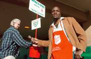 LAURA STULL, Lawrence, drops in a donation while Salvation Army volunteer Arvelle Trotter, Lawrence, rings the bell at Dillons, 3000 W. Sixth St., in this December 2005 file photo. The Salvation Army seeks volunteers to help with this year's fundraising drive. For more information, call Donnie Hornberger at 843-4188, ext. 102.