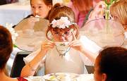 ADDIE SCHINKEL, 7, takes a sip of her drink during the Lawrence Public Library's annual Victorian Tea Party in this December 2005 file photo. This year's tea party will be Jan. 3.