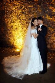 In this photo released by Rogers and Cowan, actor Tom Cruise and actress Katie Holmes pose in their wedding attire on Saturday at the 15th-century Odescalchi Castle overlooking Lake Bracciano outside of Rome.