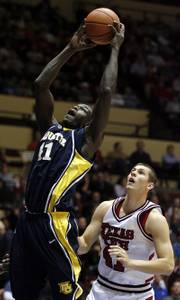 Marquette's Ousmane Barro, left, brings down a rebound in front of Texas Tech's Damir Suljagic. The Golden Eagles defeated the Red Raiders, 87-72, Monday in a semifinal of the CBE Classic in Kansas City, Mo.