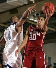 Oklahoma guard Austin johnson, right, shoots under pressure from Memphis guard Pierre Niles in the second half of a Maui Invitational matchup. No. 12 Memphis beat Oklahoma, 77-65, Tuesday in Lahaina, Hawaii.