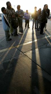 Shoppers wait outside a Kmart store at sunrise for a 7 a.m. Thanksgiving Day sale in Nashville, Tenn.