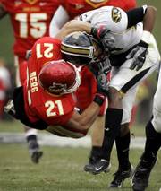 Missouri's Jared Perry, right, is tackled by Iowa State defender Caleb Berg in the Cyclones' 21-16 victory.