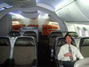 Kenneth Price, a marketing director for Boeing, sits in a mock-up of a Dreamliner cabin, which Boeing hopes will make flying a more comfortable experience. The first Dreamliner models are scheduled to be delivered to customers in 2008.