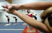 Elizabeth Marshall, director and owner of the Bikram Yoga College of India, 711 W. 23rd St., leads a yoga class in the studio on Tuesday. Kansas now ranks 17th in the United States for health, according to the latest report issued by the United Health Foundation.