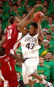 NOTRE DAME GUARD RUSSELL CARTER has his shot blocked by Alabama forward Alonzo Gee during the first half of their game. Carter scored a career-high 27 points Thursday in the Fighting Irish's 99-85 upset of the fourth-ranked Crimson Tide.