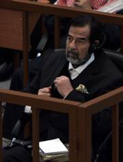 Ousted Iraqi leader Saddam Hussein sits in the dock during his trial Thursday in Baghdad, Iraq. Saddam and six co-defendants have pleaded innocent to charges of war crimes and crimes against humanity for their alleged roles in the 1987-88 military campaign against Kurds in northern Iraq.
