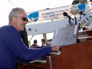 Mike Finnigan demonstrates his prowess on the Hammond B3 organ during a recent Blues Cruise performance.
At right are a selection of some of the high-profile albums on which Finnigan has appeared.