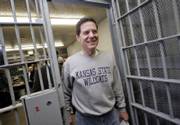 Sen. Sam Brownback, R-Kan., walks through the doors as he heads to a prayer service at the Louisiana State Penitentiary at Angola in Angola, La., on Friday. Brownback spent a night in the company of murderers and rapists less than a week after taking his first step toward a presidential run.