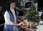 Disc jockey Sandra Harris, who has been playing holiday classics at WHOM radio station in Portland, Maine, since the day after Thanksgiving, pauses between songs at the studio. As of Monday, 402 stations from Maine to Hawaii were playing Christmas tunes around the clock to bring in listeners and advertising dollars.