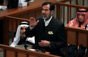 Former Iraqi President Saddam Hussein discusses prosecution evidence during his trial in Baghdad, Iraq. The chief prosecutor in Saddam's trial for genocide against the Kurds presented the most serious evidence to date Monday, implicating the deposed Iraqi leader directly in chemical attacks.