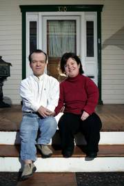 Cara and Gibson Reynolds, whose newborn died last year from a genetic condition linked to dwarfism, pose Dec. 16 on the porch of their home in Collingswood, N.J. Cara says she is outraged by opposition to using embryo screening to allow dwarf people to have dwarf children. A recent survey of U.S. clinics offering embryo screening suggests it's already happening.