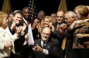 State legislators and gay rights advocates surround New Jersey Gov. Jon Corzine, center, after he signed civil unions legislation during a ceremony Thursday in Trenton, N.J. The new law will give gay couples all the rights and responsibilities but not the title of marriage, making New Jersey the third state in the nation to institute civil unions and the fifth to offer same-sex couples some version of marriage. It takes effect Feb. 19.