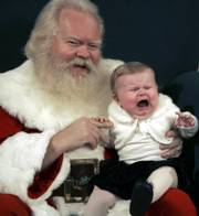 Nine-month-old Victoria Branch cries while sitting for a photo with Santa Claus Thursday at the Northpark Mall in Dallas.