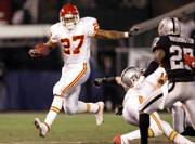 Kansas City running back Larry Johnson looks for room against the Oakland defense. The Chiefs defeated the Raiders, 20-9, on Saturday night in Oakland, Calif.