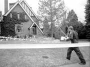 A Boulder Police detective walks to the home of John and Patricia Ramsey in Boulder, Colo., in this Friday, Jan. 3, 1997, file photo as investigators sifted through evidence in the home in which the couple's 6-year-old daughter was found murdered on Dec. 26, 1996.