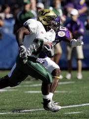 South Florida running back Benjamin Williams (30) breaks free past East Carolina defender Kasey Ross (17) for a touchdown early in the first quarter of the PapaJohns.com Bowl. Williams had two first-quarter touchdowns, leading South Florida over East Carolina, 24-7, Saturday in Birmingham, Ala.