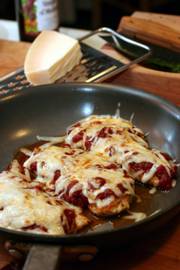 Cutting out the fat where possible by using nonfat sauce and eliminating the egg yolk for the chicken coating will help you make a lower-fat version of the classic Herbed Chicken Parmesan. This version from Cooking Light magazine&squot;s "Cooking Light Italian" uses one pan to cook the chicken, then broil it to melt the cheese.
