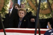 Former first lady Betty Ford is surrounded by family as she stands near the casket of her husband, former President Gerald R. Ford, Friday in Palm Desert, Calif. Ford died Tuesday at his home in Rancho Mirage, Calif. He was 93.