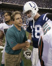 miami dolphins coach nick saban congratulates Indianapolis quarterback Peyton Manning after the Colts' 27-22 victory on Sunday. Many expect Saban to accept the University of Alabama job this week.
