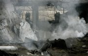 Police officers stand in the smoldering wreckage of the Barajas international airport car park in Madrid, Spain. Rescue workers searched Sunday for two people missing in the rubble of a thunderous car bomb blast blamed on the Basque separatist group ETA that shattered a 9-month-old cease-fire the group had described as permanent, officials said.