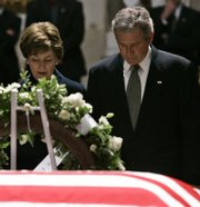 President Bush and First Lady Laura Bush pause to pay their respects by the casket of former President Gerald Ford on Monday in the Capitol Rotunda on Capitol Hill in Washington.