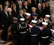 The casket of former President Gerald R. Ford is carried from Washington National Cathedral in Washington, D.C. In front row, from left, are President Bush and first lady Laura Bush; Lynne Cheney, wife of Vice President Dick Cheney; former President Carter and Rosalynn Carter; and former first lady Nancy Reagan. In the second row, from left, are former President George H.W. Bush and Barbara Bush; their daughter Doro Bush; former President Bill Clinton; Sen. Hillary Rodham Clinton, D-N.Y.; their daughter Chelsea Clinton and Secretary of State Condoleezza Rice.