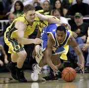 oregon's maarty leunen, left, and UCLA's Arron Afflalo dive for a loose ball during the second half of the Pac-10 Conference game. Oregon stunned No. 1 UCLA, 68-66, Saturday in Eugene, Ore. The Bruins' loss leaves just one undefeated team in college basketball - No. 23 Clemson.