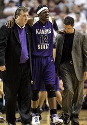 kansas state standout bill walker (12) is helped off the court by coach Bob Huggins, left, and assistant trainer Corey Driskill, right, after being injured during the first half of their game against Texas A&M. Walker played just five minutes in A&M's 69-65 victory Saturday in College Station, Texas.