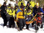 Rescue personnel bring up an avalanche survivor near Berthoud Pass, about 50 miles west of Denver. Eight people were rescued from snow-buried vehicles Saturday after the huge avalanche knocked two cars off U.S. Highway 40.