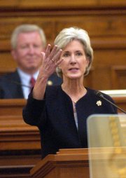 Gov. Kathleen Sebelius acknowledges Marni Vliet, president of the Kansas Health Foundation, during her State of the State speech. Sebelius proposed universal health care for Kansans and a significant expansion of early childhood opportunities in her speech Wednesday in the House of Representatives at the Statehouse in Topeka. Pictured behind Sebelius is Steve Morris, Senate president.