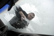 Matt Brown, a resident assistant at Kansas University's Hashinger Hall, scraped ice from his windshield earlier this month. Brown knows about dealing with ice and snow - he's from Grand Forks, N.D. A professor at Dartmouth College has created a way to make ice fall from a specially treated vertical surface.