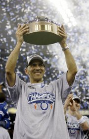 Indianapolis' Tony Dungy hoists the conference championship trophy after the Colts and Bears earned trips to the Super Bowl. The Lamar Hunt Trophy was awarded to the Colts on Sunday in Indianapolis, while the Bears won the George Halas trophy Sunday in Chicago.