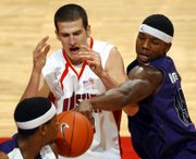 Kansas State's David Hoskins, right, and Cartier Martin defend against Iowa State's Jiri Hubalek during a Big 12 Conference game Saturday in Ames, Iowa. Kansas State was the only road team to prevail in the Big 12 this weekend.