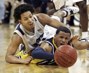 marquette's dominic james, right, reaches for a loose ball with Pittsburgh's Ronald Ramon in the second half of a Top-25 matchup. Marquette beat Pittsburgh, 77-74, in overtime Sunday in Pittsburgh.