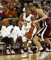 Texas' brittainey raven moves around the defense of Texas A&M's Jennifer Wilks in the second half. No. 22 Texas beat No. 17 Texas A&M, 64-45, Sunday in Austin.