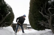 Terri Anderson clears a walkway of an elderly neighbor Sunday in Denver. The latest in a series of winter storms battered Colorado on Sunday, dumping several inches of snow and creating whiteout conditions on the state's eastern plains.