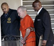 U.S. Marshal Supervisor James McIntosh, left, and U.S. Marshal Nehemiah Flowers, right, escort James Ford Seale, a 71-year-old reputed Ku Klux Klansman, from the federal courthouse Thursday in Jackson, Miss. Seale pleaded not guilty to federal kidnapping charges tied to the 1964 slayings of two black teenagers.