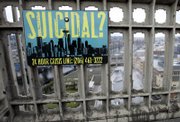 A sign advising of the phone number for a suicide-prevention hot line is shown on the Aurora Bridge in Seattle. The signs, along with telephone call boxes, were put up in December in an effort to reduce the number of people who jump to their deaths from the bridge. Eight people did so in 2006.