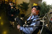 Tom Averill, right, of the Topeka band Pipers of the Plains, performs a solo on the bagpipes. Fellow band member Dana Morris is at left. The two performed Sunday night during the 11th annual Lawrence Scottish Fest at the Lawrence Arts Center, 940 N.H.